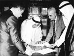 Late Amir Shk. Abdullah Al-Salem signs the agreement on the end of British colonization of Kuwait