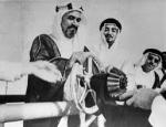 Turns the silver wheel marking the export of the first shipment of Kuwaiti crude oil