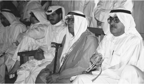 Kuwaiti men in traditional robes attend a meeting in Kuwait
